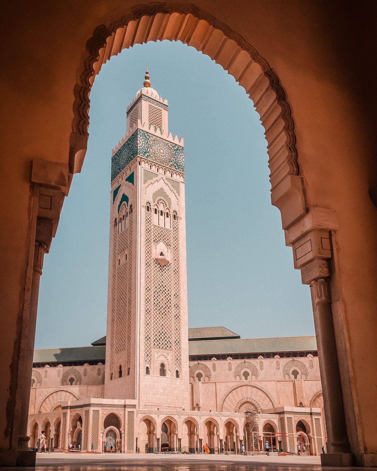 The minaret of the Hassan II Mosque in Casablanca, seen through an arch